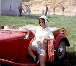 Betsy in a sporty car